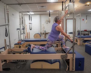 A client stretching on the reformer