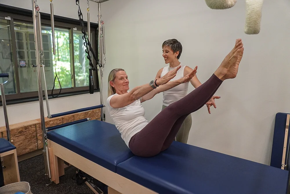 Penelope guiding a new client through a reformer session